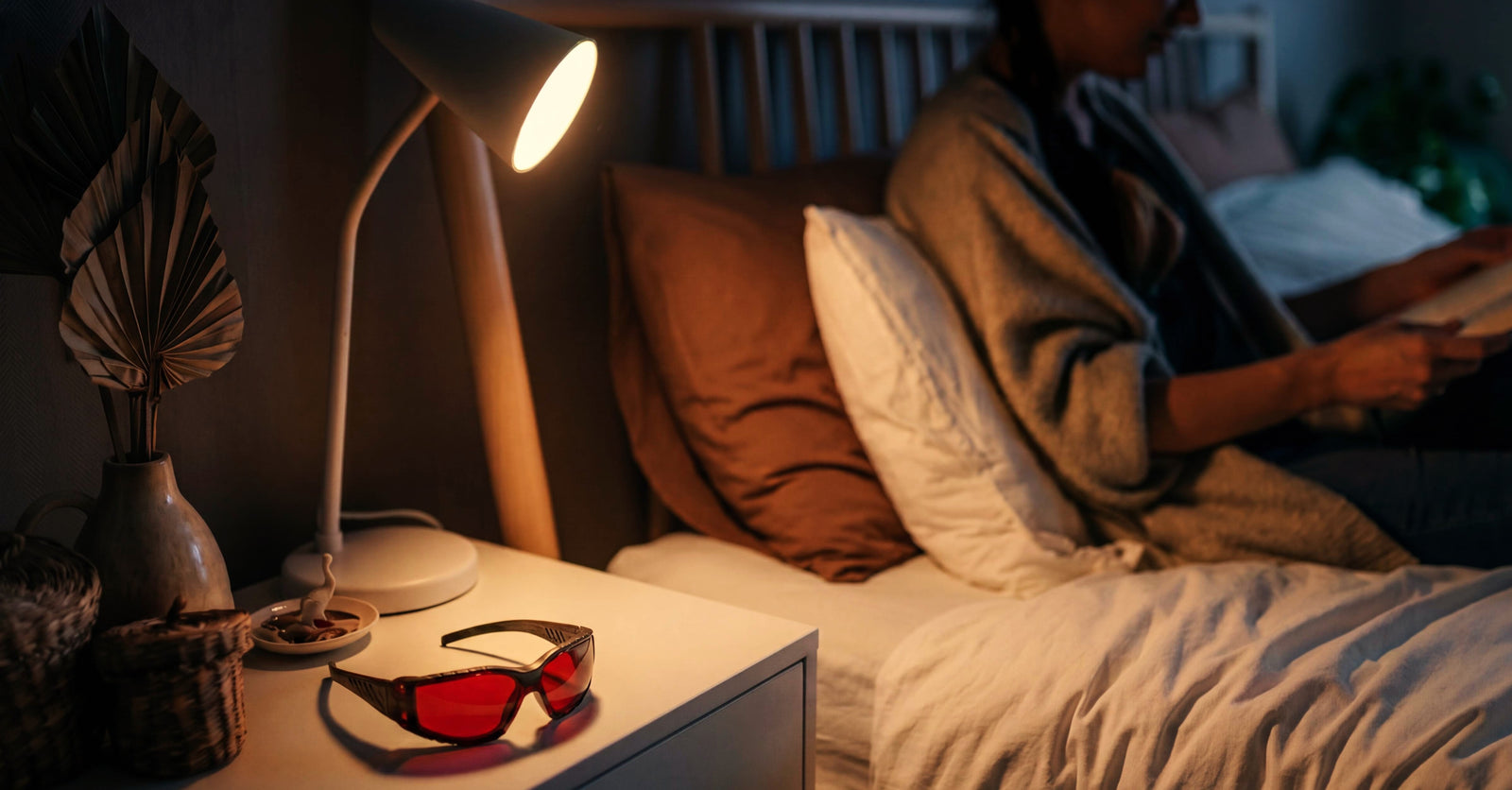 Reading in bed at night wearing Zeroblue sleep glasses